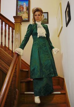 "Edwardian styled damask suit includes the long coat, skirt, and detachable jabot and cuffs. The coat measures approximately 44\" from shoulder to hem and closes with covered buttons. The matching skirt has an elastic waist. Proudly made in the US by Recollections. Damask fabric is 70% cotton & 30% polyester. Dry clean. Liesa completes the look with boots and jewelry and they are available priced separately. The following are approximate finished measurements and include room for ease of mov Elegant Long Sleeve Sets For Costume Party, Elegant Fall Ruffled Sets, Elegant Ruffled Sets For Fall, Elegant Fall Sets With Ruffles, Regency Style Victorian Dress With Ruffles For Formal Occasions, Regency Style Fitted Outerwear For Formal Occasions, Vintage Victorian Dress For Formal Winter Occasions, Regency Style Fitted Long Sleeve Outerwear, Fitted Brocade Victorian Costume Dress