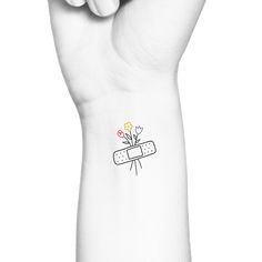 a white wrist tattoo with flowers on it