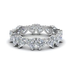 This prepossessing eternity band is a perfect gift idea for your loved one. Crafted in a gleaming metal, this diamond wedding band calls attention to its heart shaped diamond studded in classic prong setting.   Heart cut stones of 4 Total Carat Weight with Clarity VS2 and Color H in a prong setting. Total Number of Stones:- 16 This Heart Diamond Eternity Promise Ring is also available with a wide range of lustrous metals and gemstones of your choice. Free shipping within USA. One Year Luxury Heart-shaped Ring With Birthstone, Lab Grown Diamond Heart Cut Ring For Anniversary, Diamond White Platinum Eternity Band, Heart Cut Lab Grown Diamond Ring For Anniversary, Anniversary Heart Cut Lab Grown Diamond Ring, Diamond Stackable Eternity Band For Promise, White Platinum Eternity Band With Diamond Accents, Diamond White Stackable Diamond Ring For Anniversary, Diamond White Stackable Anniversary Diamond Ring