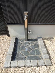 the door is open to let in some light and water into the area that's made out of cobblestones