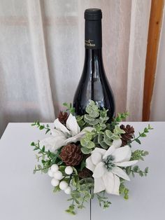 a bottle of wine and some flowers on a table