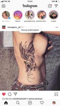 the back of a woman's stomach with a bird tattoo on it