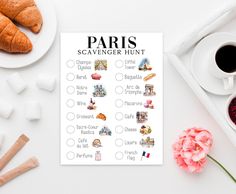 the paris scavenger hunt is displayed on a table next to coffee and croissants