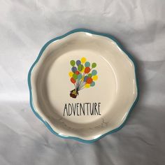 a plate with the words adventure written on it