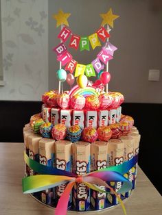 a birthday cake made out of candy and lollipops