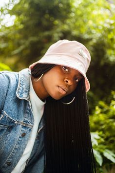 pink bucket hat on girl with long box braids and silver hoop earrings. wearing a denim jacket. Hat And Braids, Big Hair Styles, Pink Bucket Hat, Brown Satin, Bucket Hats, Big Hair, Bucket Hat, Braids, London