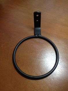 a black ring sitting on top of a wooden table