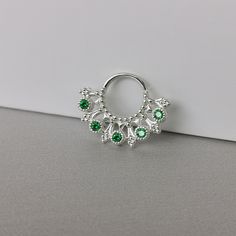 16 gauge tribal emerald Septum Ring ,Silver Daith piercing  -Material:  925 Sterling Silver -AAA Emerald CZ size: 2 x 2 mm -Hoop size: 8 x 8 mm inner  -Gauge : 16 G  ~This listing is for one sterling silver hoop piercing. **TWIST HOOP TO PUT IN**  All items will be shipped with tracking number. Please note that delivery ranges between 1-4 weeks, depending on the country of destination. Thank you for visiting Gemsfieldshop Silver Internally Threaded Small Hoop Belly Ring, Silver Hoop Belly Rings, Silver Internally Threaded Hoop Body Jewelry, Elegant Silver Septum Ring, Pierced Sterling Silver Belly Rings, Silver Small Hoop Belly Rings As Gift, Silver Sterling Belly Rings, Internally Threaded Silver Hoop Nose Rings, Silver Internally Threaded Hoop Nose Rings