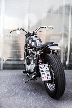 a black motorcycle parked in front of a building