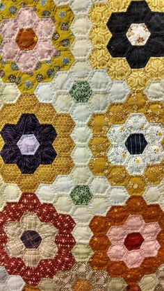 a close up of a quilt with many different colors