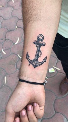 an anchor tattoo on the wrist