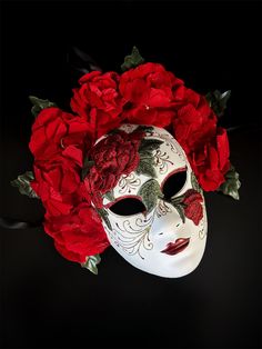 Embrace timeless elegance with this Red Rose Floral Mask, featuring intricate embroidery and vibrant red roses. Inspired by Venetian mask-making traditions, this stunning mask is perfect for masquerade balls, themed parties, or theatrical events. The luxurious red floral accents combined with the delicate embroidery make this mask a captivating statement piece.

Age Group/Gender - Adult/Women

Size/Type - One size fits all adults

Mask Color - Red/White

Mask Material - Polyresin

Special Featur Rose Masquerade Mask, Masquerade Mask Aesthetic, Day Of The Dead Masks, Masquerade Mask Women, Couples Masquerade Masks, Floral Mask, Becoming A Tattoo Artist, Rose Mask, Mask Aesthetic