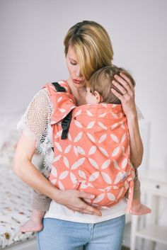 a woman holding a baby in her sling