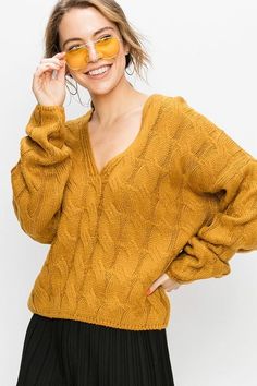 This lightweight cable knit sweater in mustard featuring a v-neckline and relaxed fit is the perfect weather wardrobe statement for your winter. Soft Cable Knit Fabrication Unlined 100% Acrylic Hand Wash Cold, Lay Flat to Dry Imported Small: Length 21" Medium: Length 21.5" Large: Length 22" Mustard Sweater Affordable, Mustard Cable Knit Sweater, Mustard Sweaters, Yellow Cable Knit Sweater, Perfect Weather, Jumpsuits And Romper, Lightweight Sweater, Knit Pullover, Knitting Women