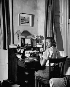 black and white photograph of a woman sitting at a desk