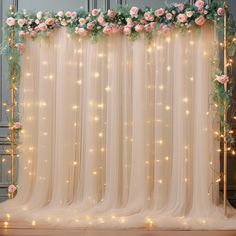 the backdrop is decorated with pink flowers and greenery for a wedding or special event