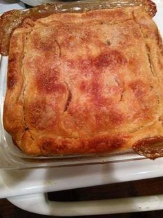 a square casserole sitting on top of a white plate