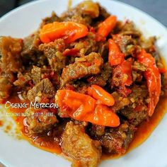 a white plate topped with meat and peppers