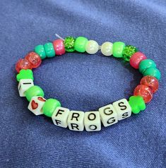 a beaded bracelet with the word frogs on it