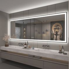 a bathroom with two sinks and a large mirror over it's counter top area