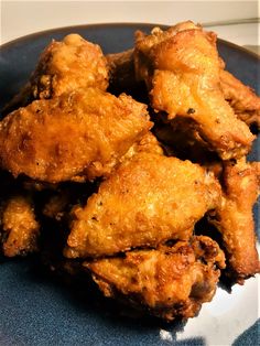 some fried chicken on a blue plate ready to be eaten