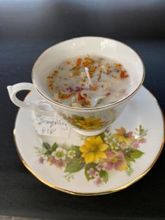 a cup and saucer with soup in it