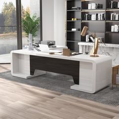 a modern office desk in the middle of a room with bookshelves and shelves