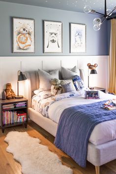 a bed room with a neatly made bed and pictures on the wall