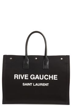 Perfect for days when you're toting a lot but still want to look Left Bank-chic, this spacious canvas tote features rolled leather handles and a bold logo. Style Name:Saint Laurent Noe Rive Gauche Logo Canvas Tote. Style Number: 6084311. Available in stores. Canvas Shoulder Bag With Logo For Errands, Chic Canvas Shoulder Bag With Logo, Logo Tote Canvas Bag For Errands, Designer Large Capacity Canvas Bag, Canvas Logo Bags For Errands, Black Canvas Shopping Bag With Logo, Chic Canvas Bags With Logo, Coated Canvas Bag With Logo For Shopping, Coated Canvas Shopping Bag With Logo