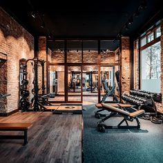 an empty gym with rows of exercise equipment