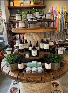 the shelves are filled with different types of candles and body care products in baskets on top of each shelf