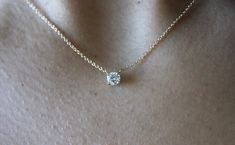 "This classic necklace features a round floating diamond basket set. Beautiful solitaire diamond necklace, perfect for a sparkly everyday look. *4 mm= .25 carats approximately. *4.4 mm= .33 carats approximately. *4.8 mm= .40 carats approximately. * Handmade in the USA. * Gold KT: 14K/18K gold. * Diamonds: Round Diamond * Color and Clarity: H (or better) / SI2 (or better). * Chain type: 1 mm cable chain, Lobster clasp. * Chain length: 15\"-16\", 17\"-18\". * Setting Type: Basket Setting. * Made t 14k Gold Solitaire Necklace With Round Cut, Timeless Everyday Solitaire Necklace With Prong Setting, Timeless Solitaire Necklace For Everyday, Timeless Everyday Solitaire Necklace, Classic Diamond Necklace With Prong Setting For Everyday, Classic Everyday Diamond Necklace With Prong Setting, Timeless 14k Gold Solitaire Diamond Necklace, Classic 14k Gold Solitaire Necklace With Single Cut Diamonds, Classic Solitaire Necklace In 14k Gold, Brilliant Cut