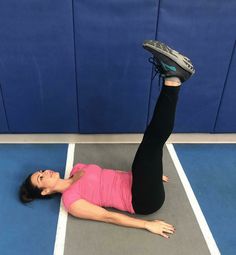 a woman laying on the ground with her feet up