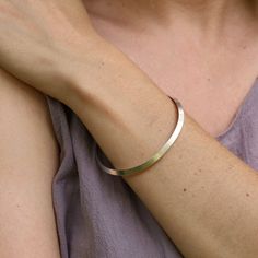 A smooth bangle with a triangular shape. These are great for layering or worn alone. Polished Sterling Silver 5mm width 2.5" inner diameter Handmade in Colorado By Nikki Nation "Modern, yet organic forms, mixed with forging and hammering techniques are what inspire my jewelry designs. All pieces are handmade using traditional methods of metalsmithing such as fabrication, forming, texturing, and stone setting. We believe in sustainability and only use recycled metals, conflict free or recycled ge Minimalist Hammered Bracelet Bangle, Minimalist Hammered Bangle Bracelet, Hammered Minimalist Bangle, Modern Hammered Bangle For Everyday Wear, Modern Hammered Bangle For Everyday, Minimalist Hammered Sterling Silver Bangle Bracelet, Minimalist Hammered Cuff Bangle Bracelet, Minimalist Hammered Bangle For Everyday, Minimalist Hammered Cuff Bracelet