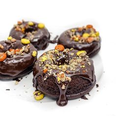 chocolate covered donuts with nuts and pecans on top