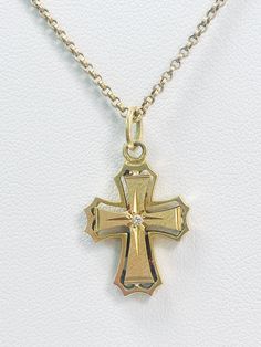 This stunning pre loved gold cross pendant, featuring a beautifully designed cross adorned with a sparkling diamond at its center. Crafted from 18ct gold it features a unique design and detailed edges. Approximately 19.5mm x 16mm Weighs approximately 3.10gm Necklace is for display purposes only. Gold Diamond Cut Cross Necklace, Yellow Gold Diamond Cut Crucifix Necklace, Yellow Gold Diamond Cut Cross Pendant Necklace, Yellow Gold Cross Necklace For Anniversary, Yellow Gold Diamond-cut Cross Pendant, Gold Crucifix Cross Necklace With Diamond Accents, Diamond Cut Yellow Gold Cross Pendant, Yellow Gold Cross Pendant For Anniversary, Yellow Gold Diamond Cut Cross Pendant