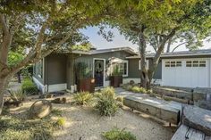 a house that has some trees in front of it