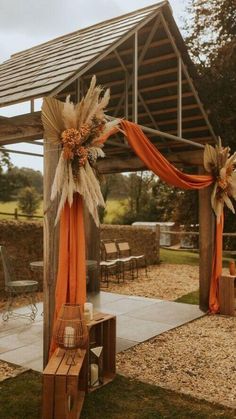 an outdoor wedding venue decorated with orange and white decor