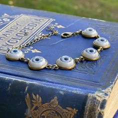 Eye cabochon bracelet in antiqued brass. Choose eye color. Metal Evil Eye Bracelet, Handmade Metal Evil Eye Bracelet, Vintage Adjustable Hypoallergenic Jewelry, Taurus Ring, Cabochon Bracelet, Eye Ball, Ball Bracelet, Cameo Ring, Ring Photos