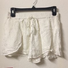 White Flowy Shorts With Lace Detailing Brand New Never Worn White Bottoms With Built-in Shorts For Summer Outings, White Cotton Shorts For Summer Outings, Chic White Shorts For Summer Outings, White Beach Bottoms For Spring, White Shorts With Elastic Waistband For Summer, White Shorts With Elastic Waistband For Summer Outings, White Bottoms For Spring Beach Outing, White Bottoms For Beach In Spring, White Spring Beach Bottoms