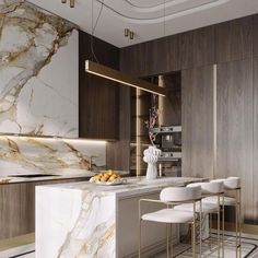 an elegant kitchen with marble counter tops and white bar stools, along with gold accents