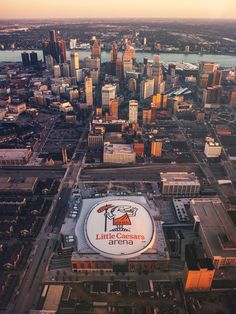 an aerial view of a large arena in the middle of a city with tall buildings