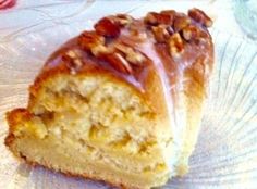 a close up of a piece of cake on a plate with frosting and nuts