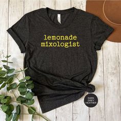 This cute lemonade mixologist tshirt celebrates the sunny weather and the yummy drinks that come along with the changing of the seasons.  Perfect for supervising the lemonade stand.  A great gift for the foodie or mixologist.  It's also a great addition if you're wanting to add a little pop of color to your warm weather wardrobe.   Checkout this lemonade tshirt listing: https://www.etsy.com/homesweetpdx/listing/1449967240/lemonade-mixologist-tshirt-lemon-tshirt?utm_source=Copy&utm_medium=Listing Summer Brunch T-shirt With Screen Print, Summer Shirt With Funny Text, Funny Text Shirt For Summer, Casual Lemon Tops For Summer, Funny Shirt With Text Print For Summer, Funny Text Print Shirt For Summer, Summer T-shirt With Screen Print For Brunch, Summer Brunch Cotton T-shirt, Summer Cotton T-shirt For Brunch