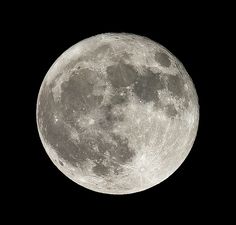 the full moon is visible in the dark sky