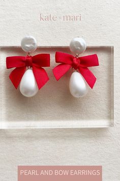 Sweet and simple, our pearl and bow earrings feature a mother of peal drop, a freshwater coin pearl stud measuring 12mm and a mini bow measuring 1 1/4 inches wide. Total length is approx 2 inches long and 1.25 inches wide. Part of our demi fine collection. Available in ivory, red, black and navy. White Pearl Earrings With Bow For Wedding, White Bow Pearl Drop Earrings, Pearl Jewelry With Bow Detail, Elegant Red Jewelry With Bow, White Jewelry With Bow For Gifts, Gift Pearl Earrings With Pearl Charm, Red Pearl Earrings As A Gift, Elegant Jewelry With Red Bow For Gifting, Pear-shaped Pearl Earrings Gift