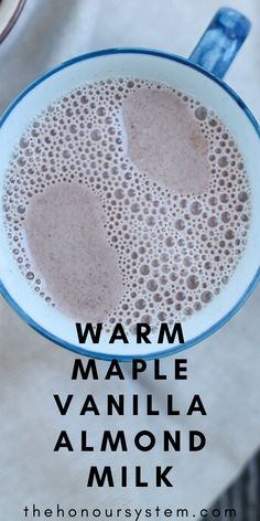 a close up of a cup of liquid with the words warm maple vanilla almond milk