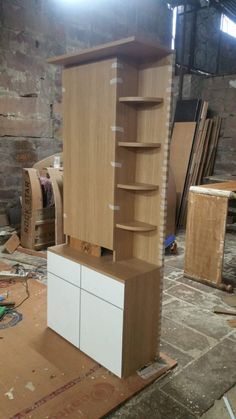 an unfinished cabinet is shown in the middle of being built with wood veneers