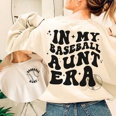 Support your niece or nephew at their next baseball game! This in my era shirt features a baseball and "baseball aunt" on the front pocket design and a retro inspired back that says "in my baseball aunt era." You're sure to be the cool aunt in this sweatshirt! Also great as a gift from niece, gift from nephew, gift for sister, or any gift for aunt, especially your favorite aunt. Your order is supporting a sports mama's small business. Thank you so much!  ♡ How to order ♡ Please select a color (a Baseball Season Fan Merchandise Sweatshirt, Casual Personalized Tops For Game Day, Casual Personalized Tops For Baseball Season, Baseball Aunt, The Cool Aunt, Front Pocket Design, In My Era, Aunt Sweatshirt, Aunt Birthday Gift