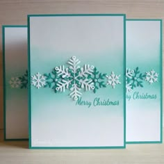 two cards with snowflakes on them, one is green and the other is white